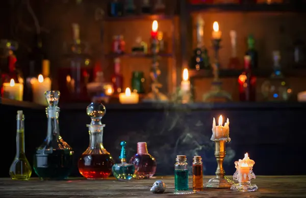 magic potions in bottles on wooden table