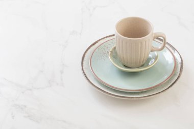 Beyaz mermer masada seramik fincan ve tabak