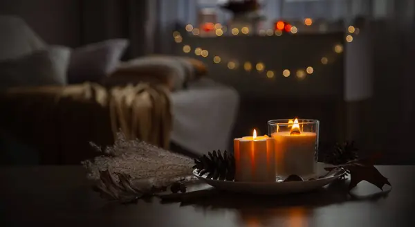 autumn and winter home decor with burning candles