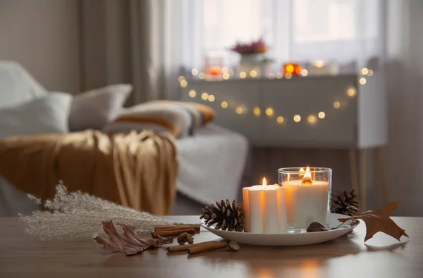 autumn and winter home decor with burning candles