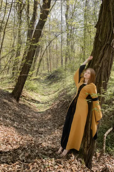 Ortaçağ elbiseli genç kadın bahar ormanında