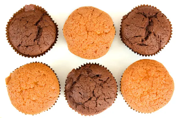 Set of muffins or cupcakes. Sweet bakery dessert with chocolate and vanilla flavors from top view.