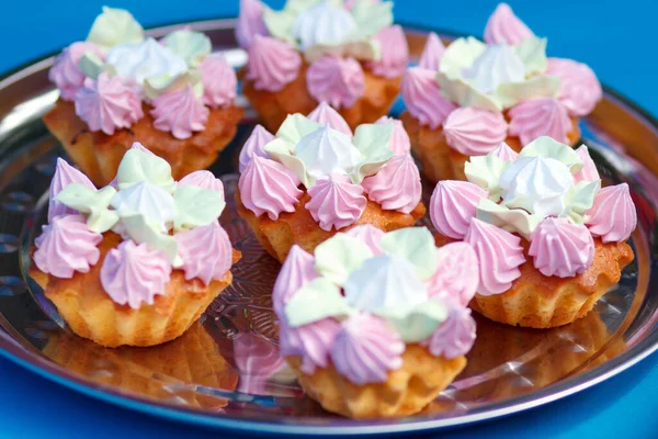 Sweet cupcakes with cream on catering table