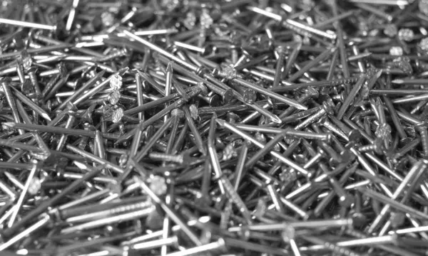 The heap of metallic nails closeup view. Household equipment for building or repair.