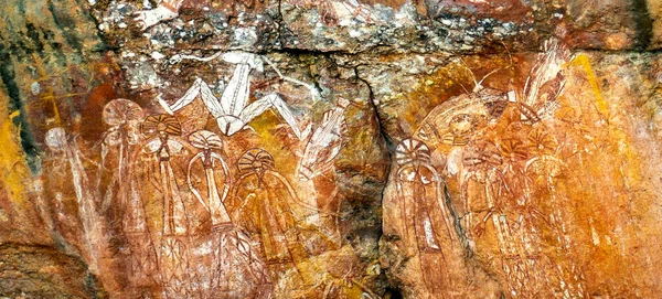 View of Barrgini, wife of Namondjok, and below a large group of men and women with elaborate ceremonial headdresses, in Kakadu, Northern Territory, Australia