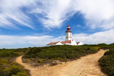 Lighthouse built in 1790 at Cape Espichel, a beautiful promontory plateau 130m above sea level in the Atlantic Coast of Portugal clipart