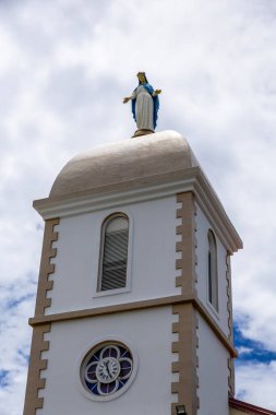 Bell tower and clock of the Church of the Immaculate Conception built in 1855 by the Marist Fathers in Mont-Dore, Noumea, Grande Terre Island, New Caledonia clipart