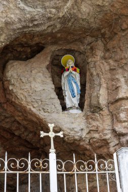 Grotto of Our Lady of Immaculate Conception in the grounds of Saint Joseph Cathedral, in Noumea, capital city of New Caledonia, the French territory of the South Pacific clipart