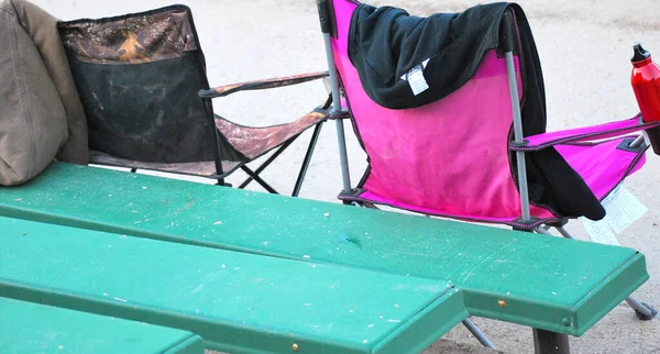 Folding chair seats at an outside event.