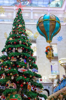 MOSCOW, RUSSIA - 7 Aralık 2016: Orta Çocuk Mağazası 'ndaki bir alışveriş merkezinde süslemeli Noel ağacı. Arka planda yürüyen insanlar. Yeni yıl, kış tatilleri, hediyeler....