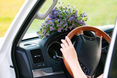 Bir arabanın torpido gözünde bir buket kır çiçeği.