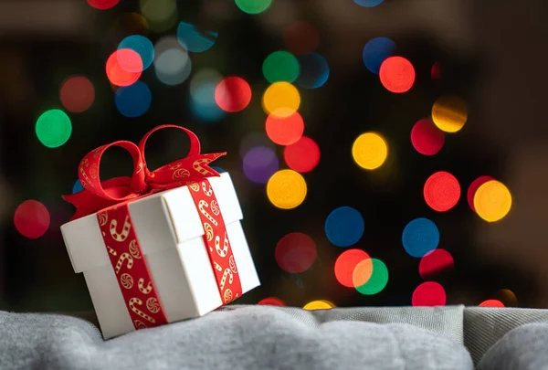 White Gift Box Red Ribbon Front Christmas Tree Background — Stock Photo, Image