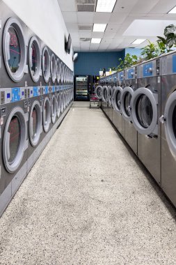 Los Angeles, California, USA - Dec 26 2022 : Coin laundry shop with washing machines lined up in room