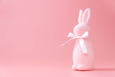 Pastel colored easter bunny decoration on pink background