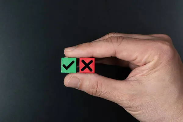 stock image Hand hold wooden blocks with a green check mark and red cross x, choice and decision making concept, yes no, approve disapprove or right wrong decision