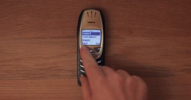 Budapest, Hungary - Circa 2022: Playing classic game Snake II on a Nokia 6310i cellphone, iconic device from the early 2000s. Strating new game