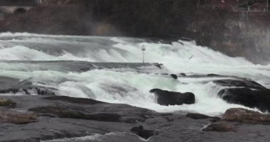 Rhine Falls waterfall in Switzerland, water rushing down the rocks