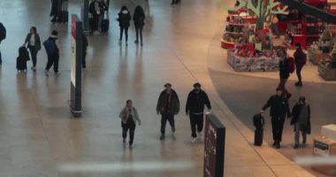 Berlin, Germany - Circa 2022: Interior of the the terminal building at Berlin Brandenburg international airport, passengers passing by duty free shops