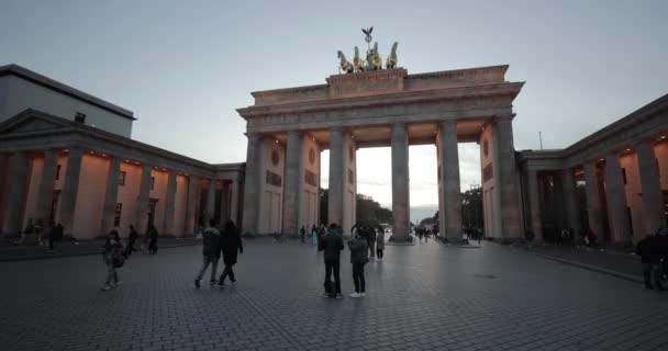 ベルリン ドイツ Circa 2022 ベルリンの中心部にある歴史的なランドマークであるブランデンブルク門による観光客 夜の記念碑 パリ広場から歩いて — ストック動画