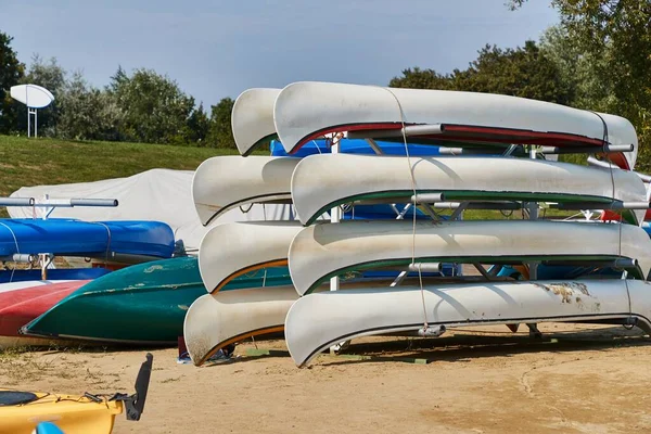 Many canoes and kayaks stored at a renting place on the beach