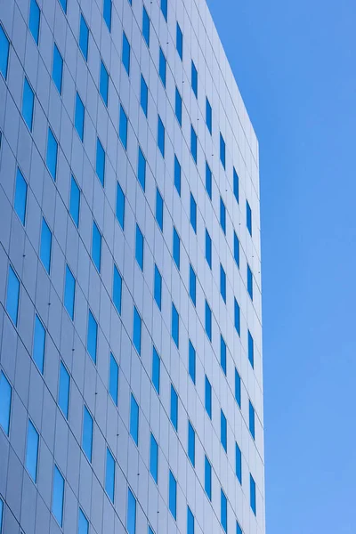 市内の青い空を反映した窓のあるオフィスビルの詳細 — ストック写真
