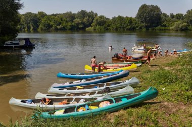 Tiszafoured, Macaristan - 19 Ağustos 2019: Nehir kenarına park etmiş kanolar, aktif yaz tatili insanları