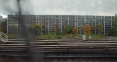 Train ride in Berlin, city buildings passing by from the window of a local train.