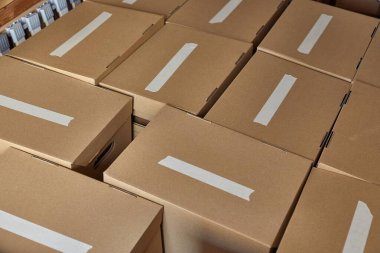 Cardboard boxes packed for moving houses, blank labels clipart