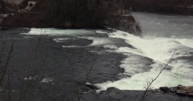 Rhine Falls waterfall in Switzerland, water rushing down the rocks
