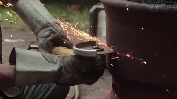 ジャンクヤードの角度グラインダーで錆びた金属アーティファクトを切断する — ストック動画