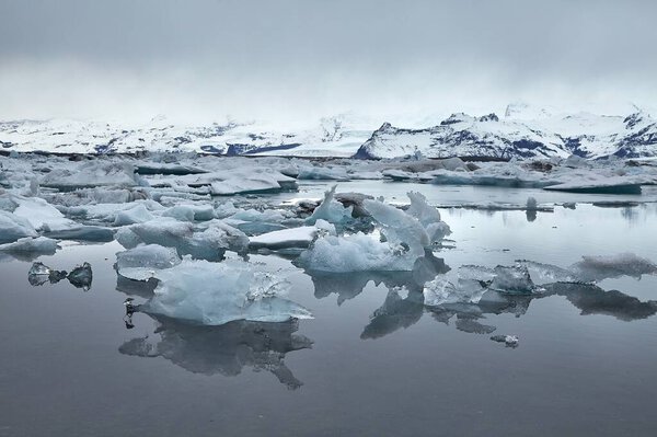 Glacial lake in Jokulsarlon, Iceland, blocks of icebergs in overcast weather