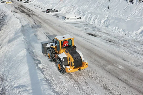 Snow plow machine clearing snow from roads after heavy snowfall in the Alps