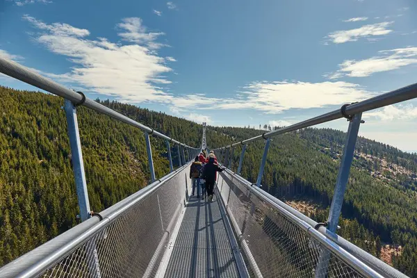 stock image View on Skybridge 721, crossing the longest suspension bridge in the world, Czech Republic. Unrecognizable people in the distance