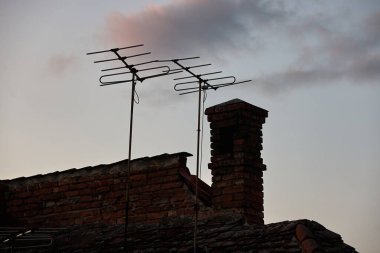 Rf antennas on an old rooftop clipart