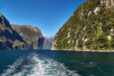 Iconic landscape at Milford Sound in Fiordland, New Zealand. Going on a touristic boat ride