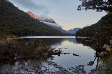 Mountain lake landscape in New Zealand along Routeburn Track great walk walk hiking trail clipart
