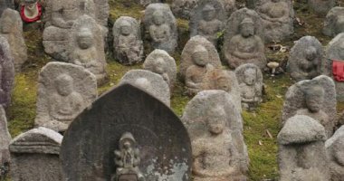 Kyoto, Japan - September 25, 2018: Shrine garden with lots of small stone sculptures, in a Japanese Shrine, Fushimi Inari Taisha