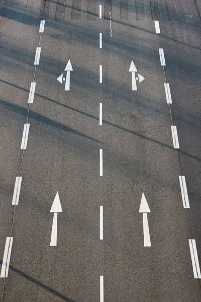 stock image Arrow signs on the asphalt road, many lanes of an urban street