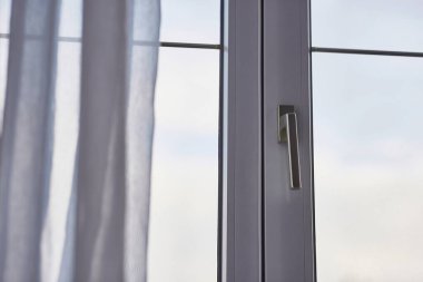 Bulutlu gökyüzüne bakan bir odanın penceresi