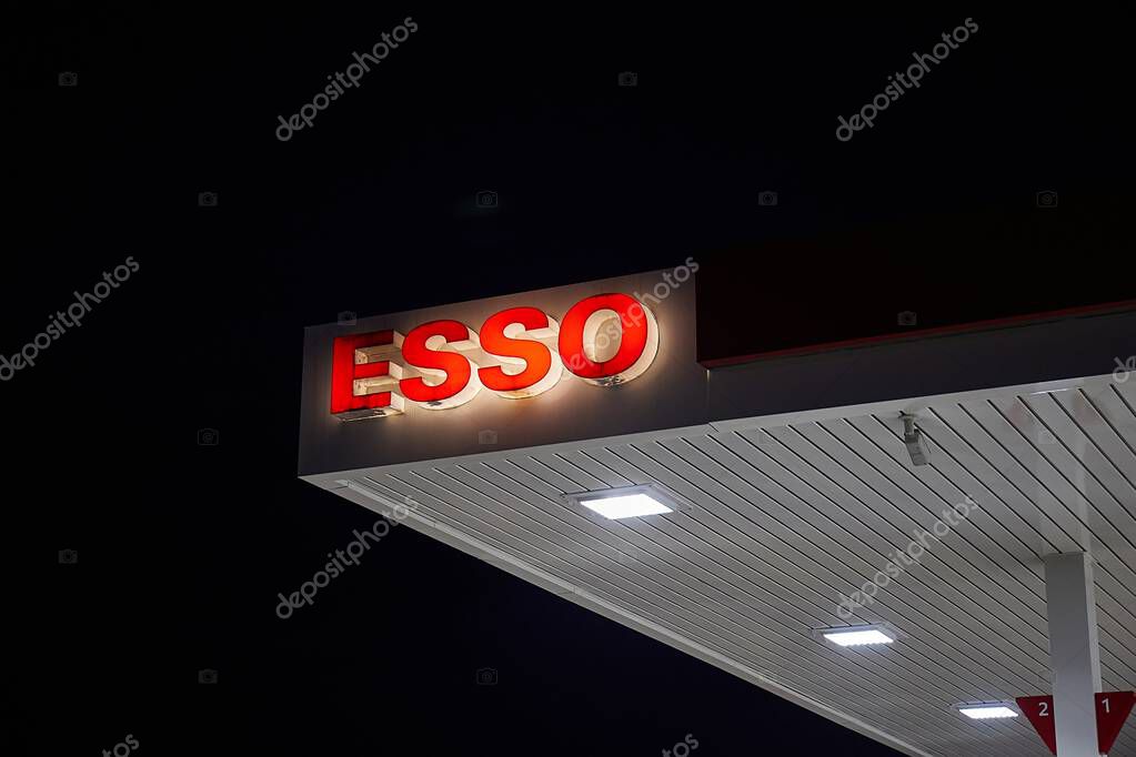 Udine, Italy - January 18, 2025: Petrol station Esso logo sign glowing in the dark night