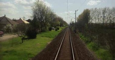 Train on a small single track rural line, view from the back of the train