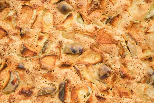 Background of homemade apple cake. Baked apple cake, top view. Pie texture.