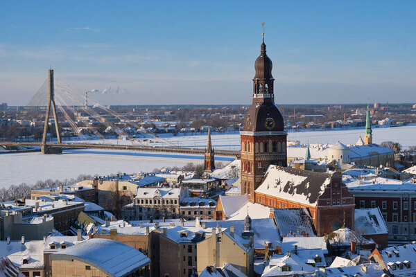 Panoramic view from tower of Saint Peters Church on Riga Cathedral and roofs of old houses in old city of Riga, Latvia in winter.