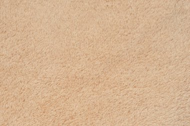 Bej renkli mikrofiber kumaş dokusu, yumuşak ve pelüş, arka plan, yüzey ve tasarım elementleri için ideal. Yüksek çözünürlüklü tekstil