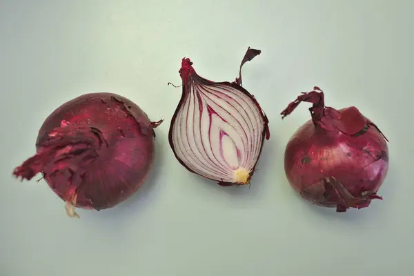 Three Red Onions Simple Background Stock Photo