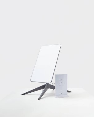 KYIV, UKRAINE - JANUARY 24, 2023: Starlink antenna and wi-fi router on white background.
