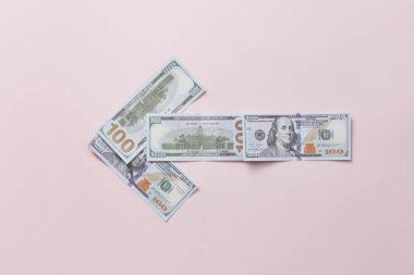 Sol tarafta bej arka planda dolar banknotlarından yapılmış, mesaj için yeri olan bir ok var. Nakit akışı konsepti, minimalist tasarım.