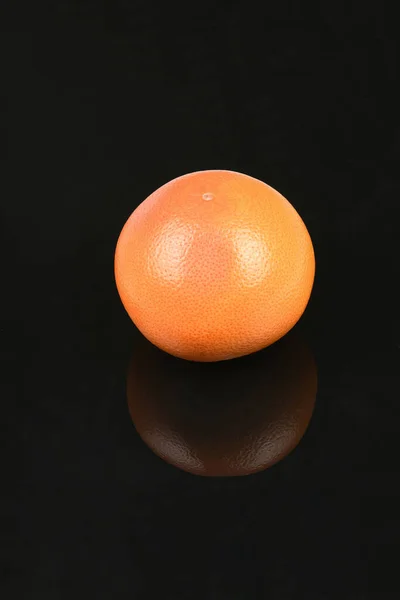 Grapefruit isolated on acrylic black background. High resolution photo. Full depth of field.