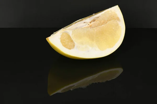 Pomelo isolated on acrylic black background. High resolution photo. Full depth of field.