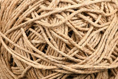 A skein of linen string, cord isolated. Coil of twine. Jute rope. Hemp thread isolated. A skein of brown wool for knitting on a white background. High resolution photo. Full depth of field.